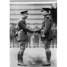 King George V presents the Victoria Cross to Captain RC Grieve at Buckingham Palace. 1917